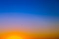 Background with gradient sunset sky in tones of yellow, orange and blue Royalty Free Stock Photo