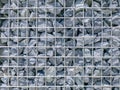 Background of Gravel Stones Wall with Metal Wire Mesh