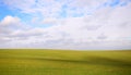 Background of green field with blue sky and clouds Royalty Free Stock Photo