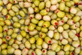 Background of green olives, stuffed with hot peppers,