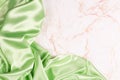 Background with green silk fabric on light marble Royalty Free Stock Photo