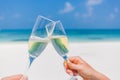 Champagne glasses in hands on beach background. Romantic honeymoon background Royalty Free Stock Photo