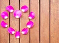 Background of heart from fresh rose petals. Creative layout with beautiful pink flower leafts. Royalty Free Stock Photo