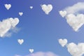 Clouds shape hearts on blue sky