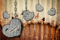 Background hearts of steel with scratches hanging on chains Royalty Free Stock Photo