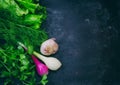 Background with herbs, lettuce, onion, garlic, on black shabby t