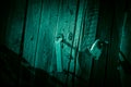 Background horror, scary, darkness. A ghostly gloomy door and a fence, a black wooden gate with a lock, the entrance to the Royalty Free Stock Photo