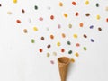 Background with ice cream cone with many colorful jelly beans on white background Royalty Free Stock Photo