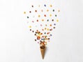 Background with ice cream cone with many colorful jelly beans on white background Royalty Free Stock Photo