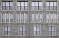 Background image - brick wall of a building with windows of different sizes