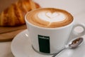 Background image of cappuccino in lavazza cup with croissant Royalty Free Stock Photo
