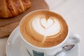 Background image of cappuccino in lavazza cup with croissant Royalty Free Stock Photo