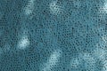 Background image - a fragment of a wall covered with turquoise plaster with holes