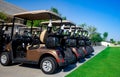 Background image of Golf carts parked on a golf closure in a line Royalty Free Stock Photo