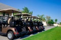 Background image of Golf carts parked on a golf closure in a line Royalty Free Stock Photo