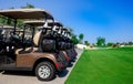 Background image of Golf carts parked on a golf closure in a line Royalty Free Stock Photo