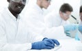 Background image of a group of scientists at the laboratory table