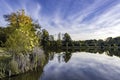 Background image of a lake with fall folliage and blue sky with