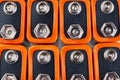 Background image of a large number of orange batteries, standing in several rows