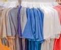 Background image of many shirts and many colors walking in a shopping mall.