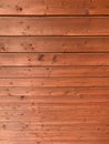 Background image of red horizontal wooden boards with small nails descending from top to bottom, perspectiv