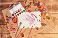 Background image showing interest in watercolor painting and art. A painted sheet of paper, surrounded by brushes, jars of waterc Royalty Free Stock Photo