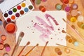 Background image showing interest in watercolor painting and art. A painted sheet of paper, surrounded by brushes, jars of waterc Royalty Free Stock Photo