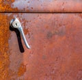 Sunlit lever door handle on a rusted side door