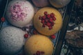 Handmade bath bombs with dry berries and flower petals. Royalty Free Stock Photo