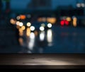 Image of a wooden bar by a window in a pub in front of the blurred lights of a night city Royalty Free Stock Photo