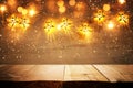 Background image of wooden board table in front of Christmas warm gold garland lights. filtered image. selective focus. glitter Royalty Free Stock Photo