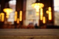 Background Image of wooden table in front of abstract blurred restaurant lights Royalty Free Stock Photo