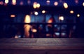 Background Image of wooden table in front of abstract blurred restaurant lights Royalty Free Stock Photo