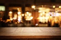 Background Image of wooden table in front of abstract blurred restaurant lights Royalty Free Stock Photo