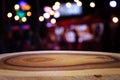Background Image of wooden table in front of abstract blurred restaurant lights Royalty Free Stock Photo