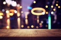 background Image of wooden table in front of abstract blurred restaurant lights Royalty Free Stock Photo