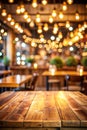 Background Image of wooden table in front of abstract blurred restaurant lights Royalty Free Stock Photo