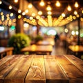 Background Image of wooden table in front of abstract blurred restaurant lights Royalty Free Stock Photo