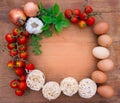 Rustic wooden background rim with spaghetti food ingredients garlic tomatoes onion eggs and space for text Royalty Free Stock Photo