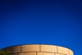 Background of intense blue sky in an industrial area with a brick construction with round shapes Royalty Free Stock Photo