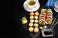 Background with Japanese sushi set and green tea on black board Royalty Free Stock Photo