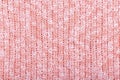Background from knitted cotton thread in coral and white.Soft focus. Concept of decoration, design for textured surface of