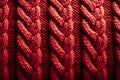 Background of a knitted pattern with red thread pigtails