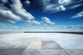 Background of a landscape with a blue sky, lovely clouds, and an empty concrete floor Royalty Free Stock Photo