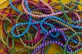 Background of large amount marid gras bead on yellow