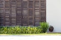 Background latticed wooden doors texture on the white wall in the tropical house in Thailand. Close up