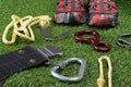 On the background of the lawn, tourist items, shoes, rope for climbing and carabiners