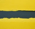 Background of layered yellow torn paper with a shadow on a black background