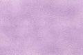 Background of light violet suede fabric closeup. Velvet matt texture of lilac nubuck textile