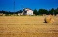 Background. lowland landscape with farm. field with bales of harvested hay. Royalty Free Stock Photo